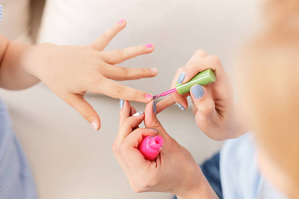 Ready to summer. Close up of mother with daughters with colorful fingernails enjoying summer